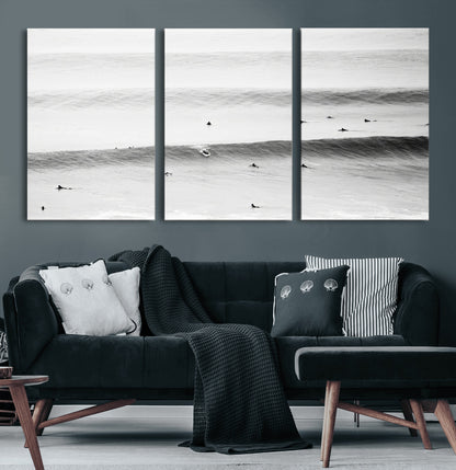 A monochrome photograph of swimmers gliding through gentle ocean waves, evoking a sense of calm and movement.