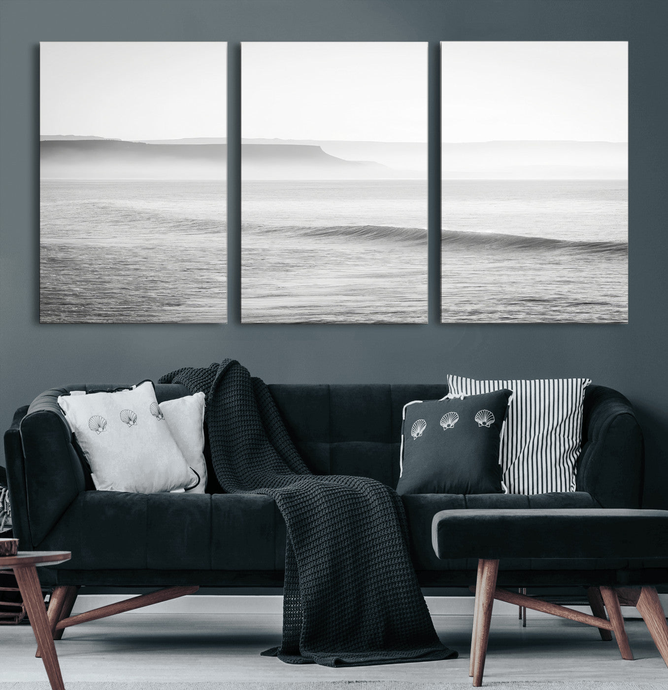 A black and white minimalist seascape featuring soft rolling waves and misty distant cliffs, creating a serene and timeless coastal atmosphere.