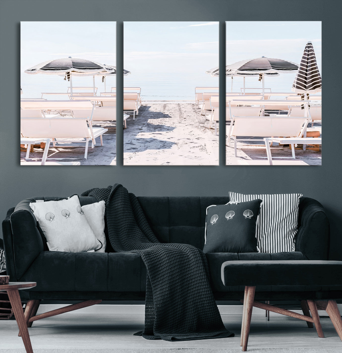 A serene minimalist beach scene featuring striped umbrellas, soft pastel sand, and an elegant lounge setup, creating a tranquil and stylish coastal retreat.