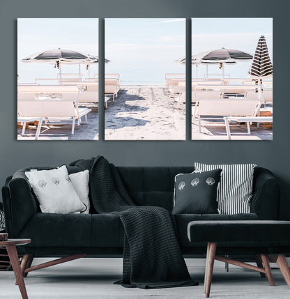 A serene minimalist beach scene featuring striped umbrellas, soft pastel sand, and an elegant lounge setup, creating a tranquil and stylish coastal retreat.