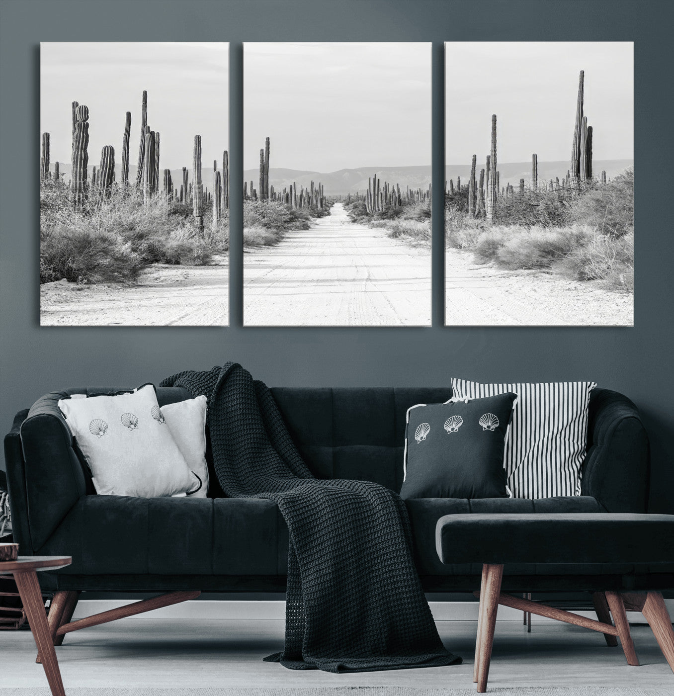 A black and white desert road stretching through a cactus-filled landscape, creating a rugged and timeless southwestern aesthetic with a sense of adventure.