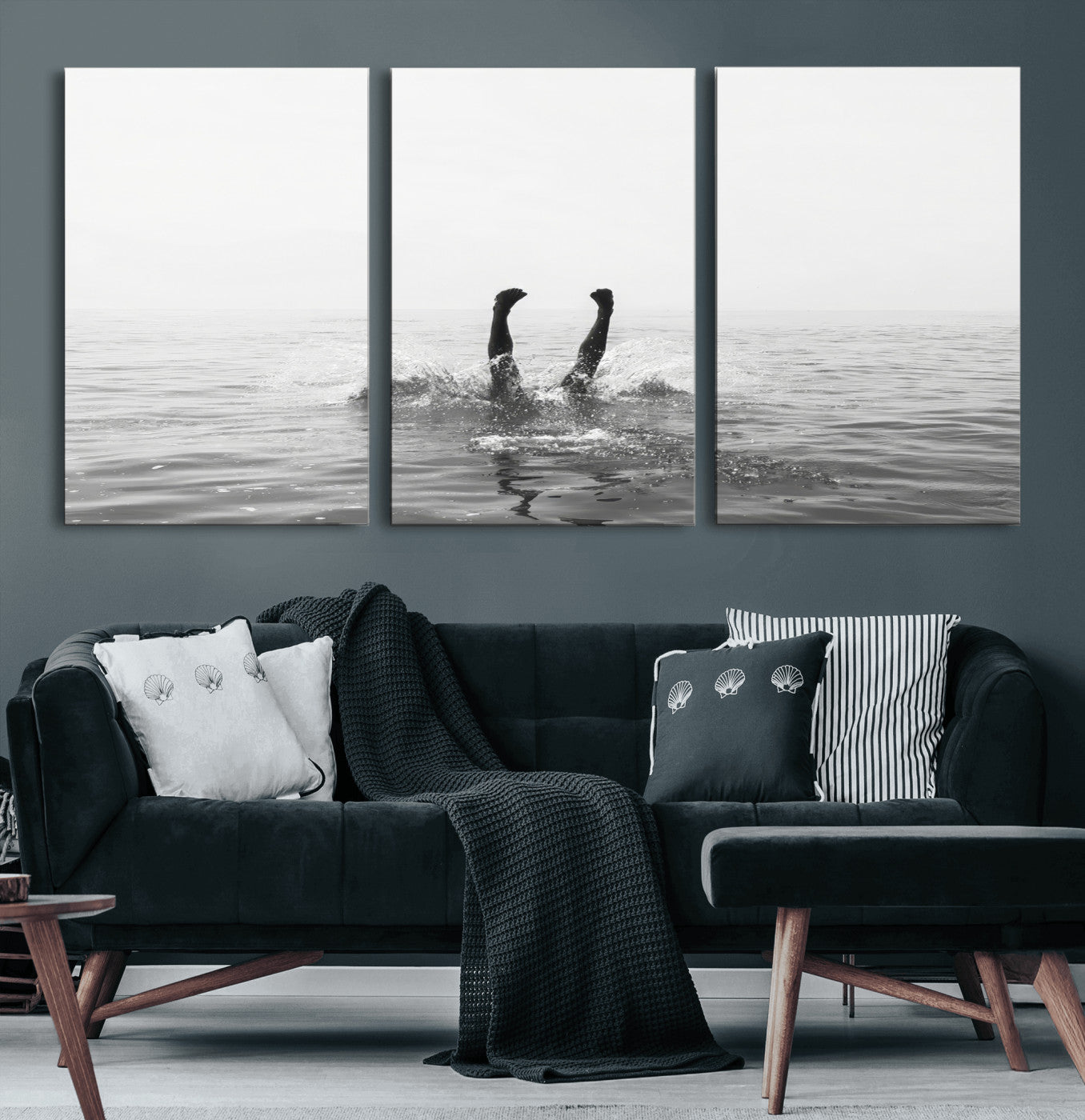 A black and white minimalist water scene capturing a playful splash as a swimmer dives upside down, creating a carefree and artistic aquatic aesthetic.
