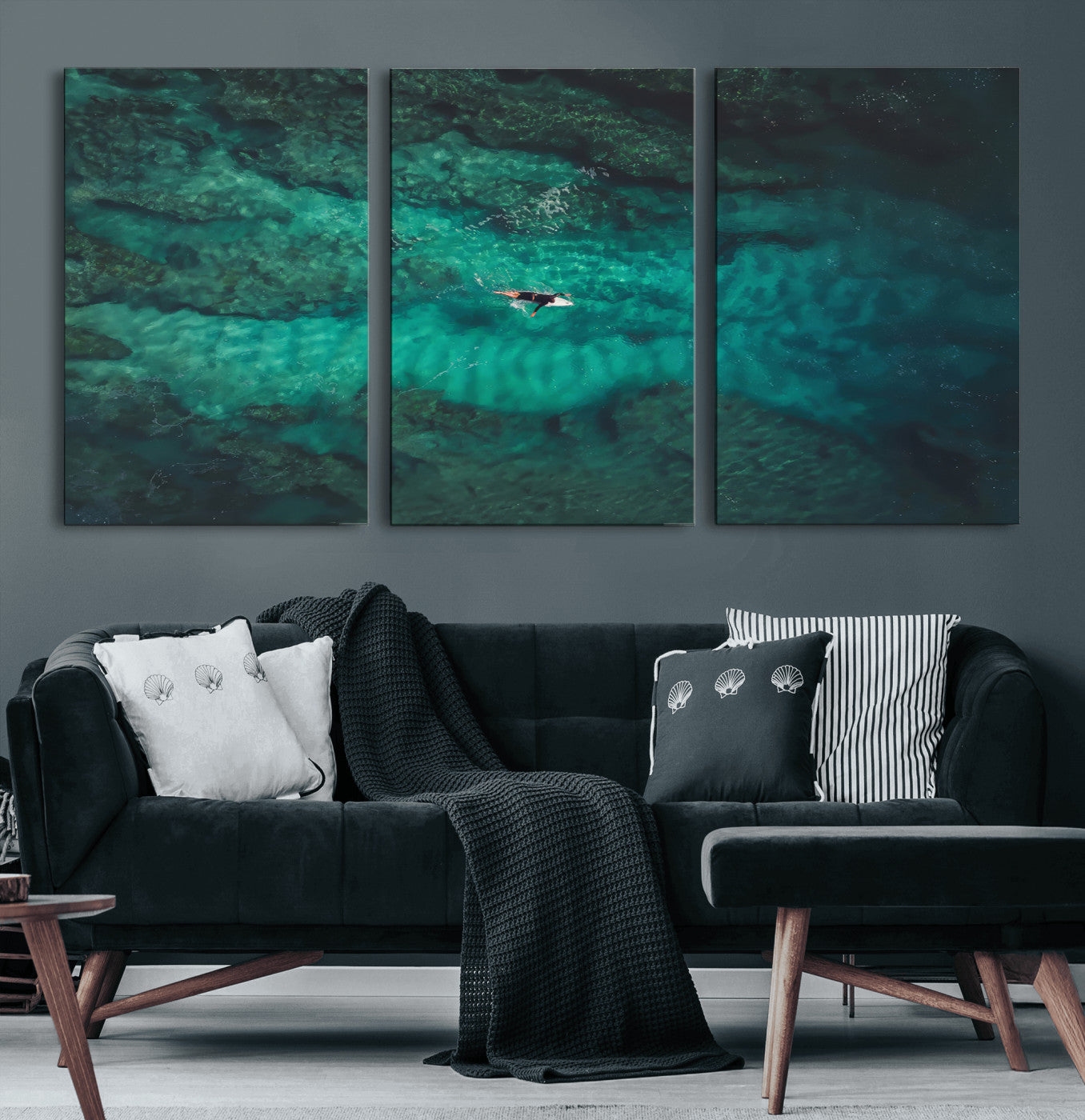 An aerial view of a solo surfer paddling through crystal-clear turquoise waters over a sunlit reef, capturing the beauty and serenity of open water surfing.