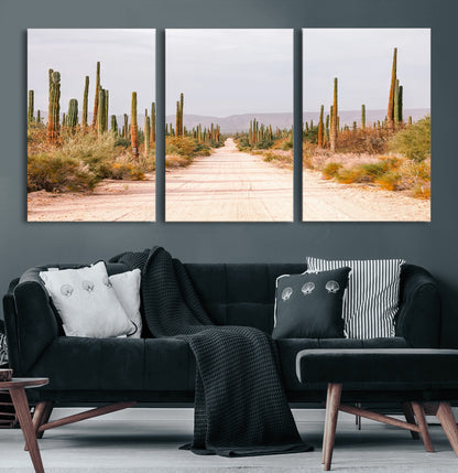 A desert road lined with saguaro cacti under a golden sky, creating a warm southwestern feel, perfect for boho or rustic decor.