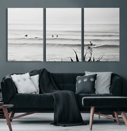 Monochrome canvas of surfers on calm ocean waves, ideal for minimalist coastal or beach-inspired interior decor.
