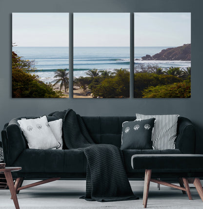 View of calm ocean waves with palm trees and a tropical coastline, ideal for coastal boho or beach-themed wall decor.