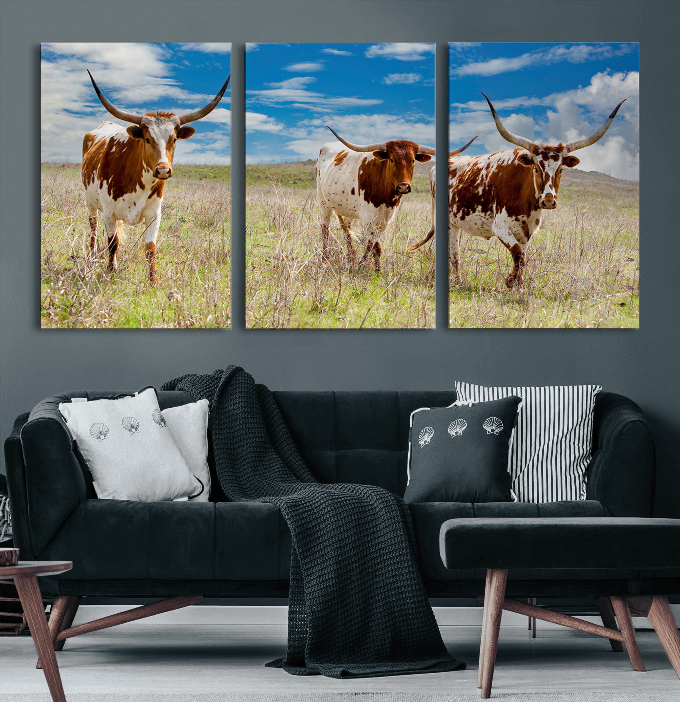 Three Texas longhorn cattle standing in dry grass under a bright blue sky, ideal for farmhouse or western rustic home decor.
