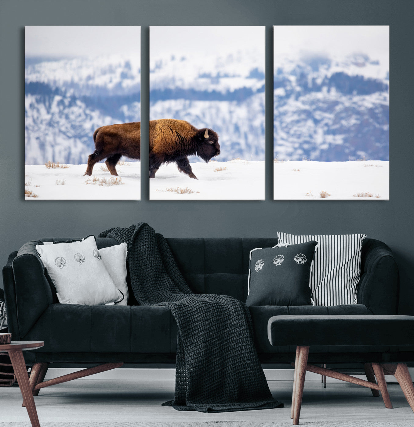 A lone bison walks across snowy ground with blue-toned mountain range behind, ideal for rustic or western farmhouse interiors.