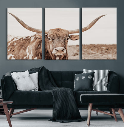 A longhorn cow in soft beige desert tones, standing calmly in open land, perfect for neutral western or rustic farmhouse interiors.