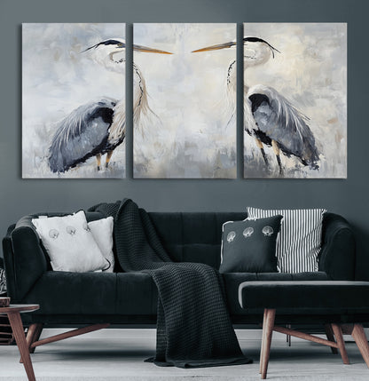 Two herons facing each other on a soft-toned background with blue-grey feathers, perfect for tranquil, coastal or nature-themed interiors.