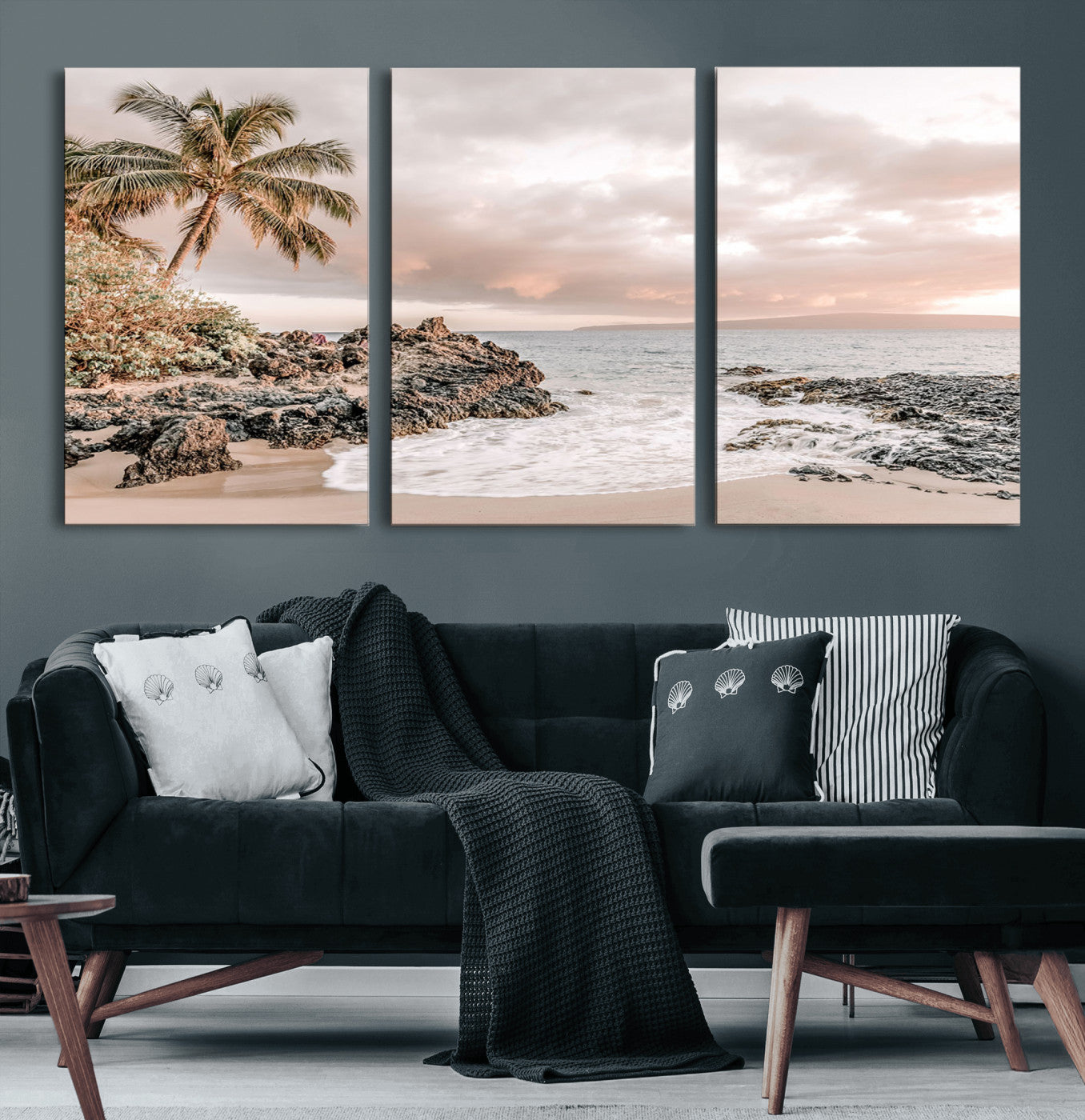 A peaceful beach scene with a palm tree and rocks, soft waves washing onto the shore under a soft pastel sky at sunset.