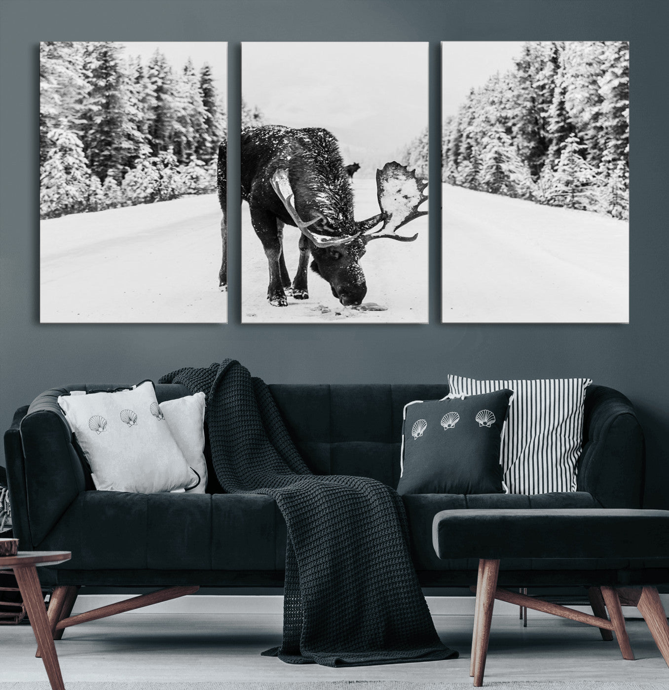 A majestic moose grazing in the snow-covered wilderness, surrounded by snow-covered trees, creating a peaceful winter scene.