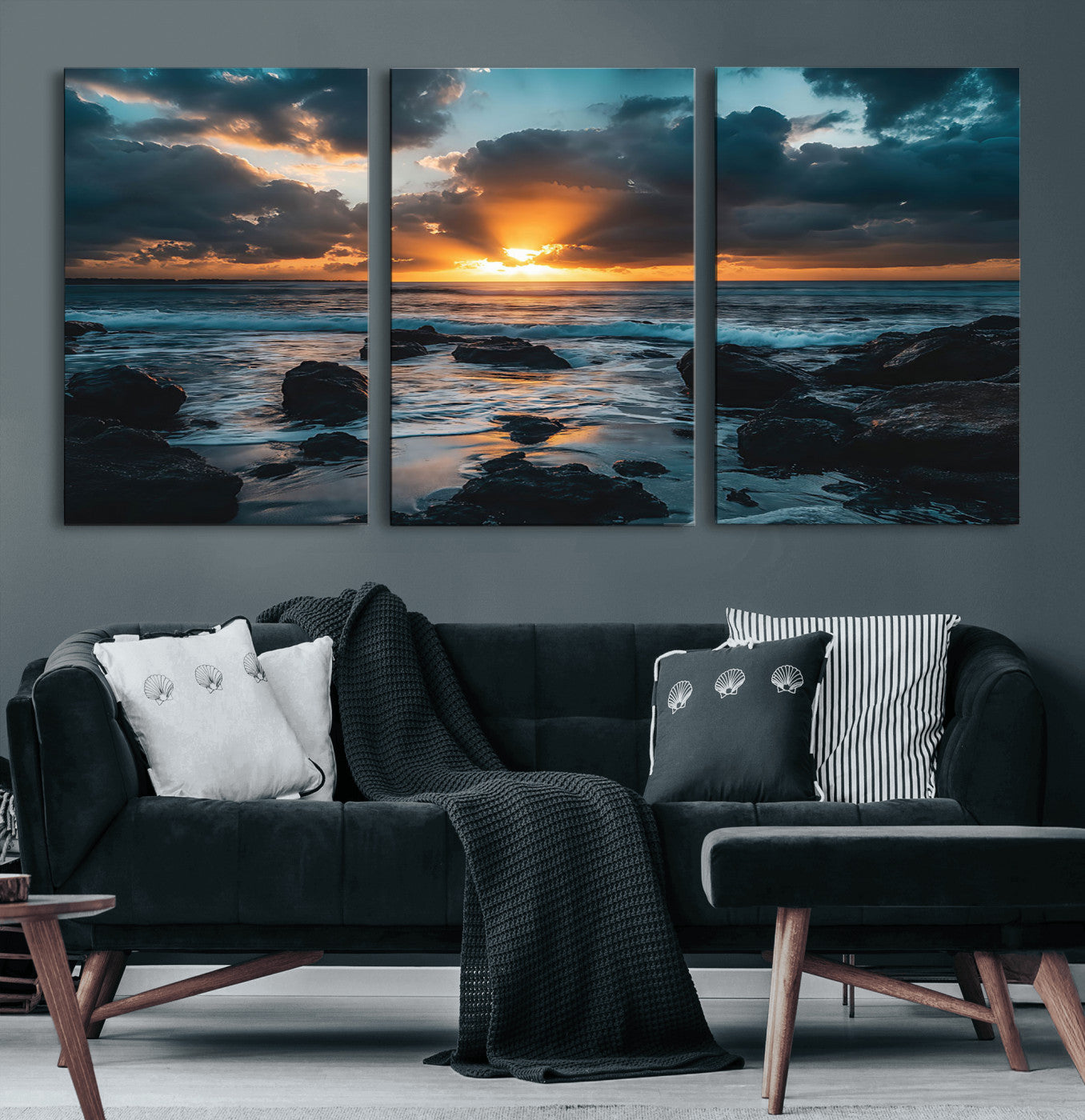 An awe-inspiring sunset over the ocean with rays of light piercing through dramatic clouds, creating a beautiful seascape with rocks in the foreground.