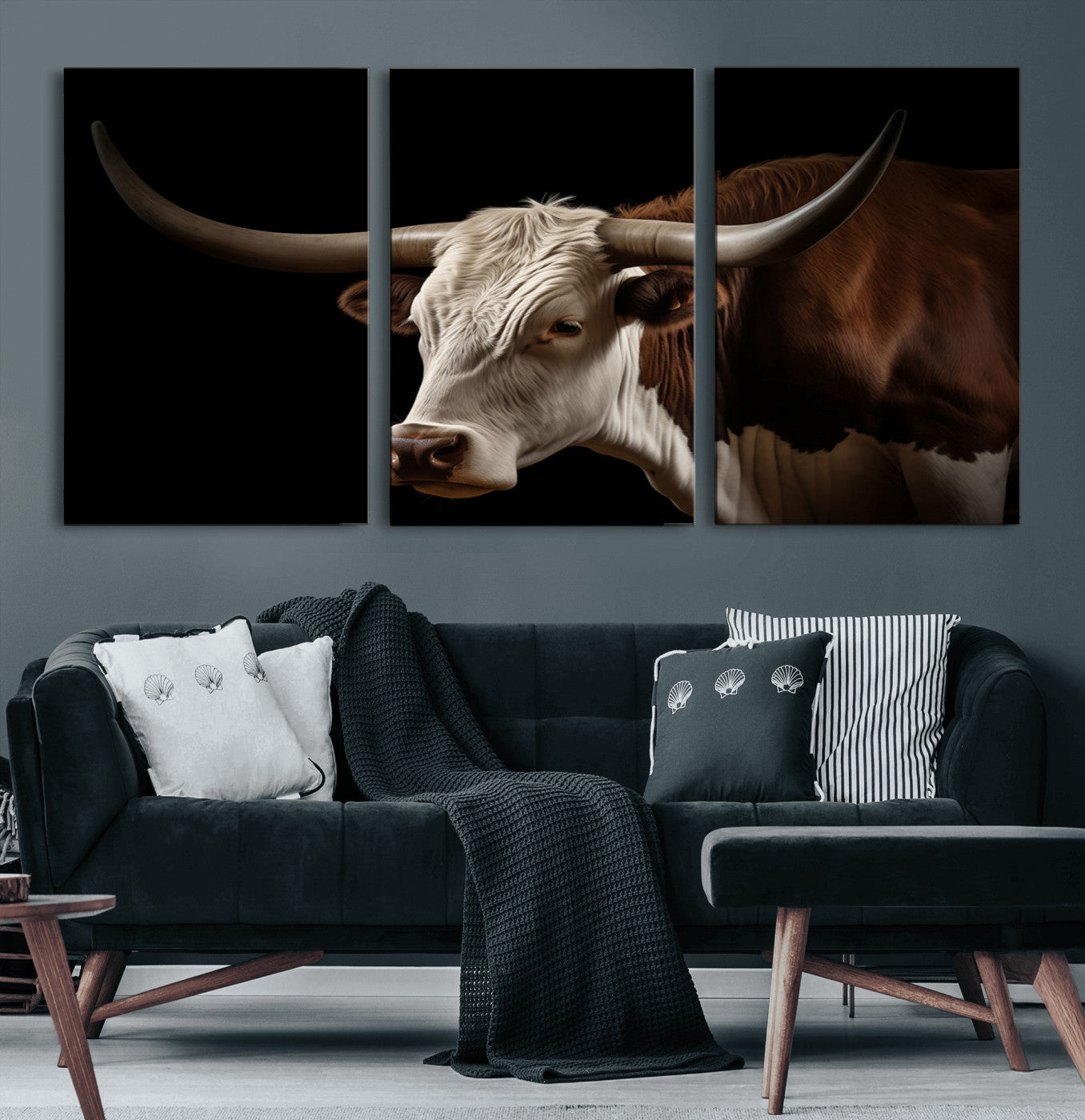 "Close-up of a brown and white longhorn cow with prominent curved horns against a black background."