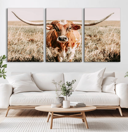 Framed longhorn cow canvas wall art with rustic prairie background, western animal print perfect for farmhouse or ranch style decor