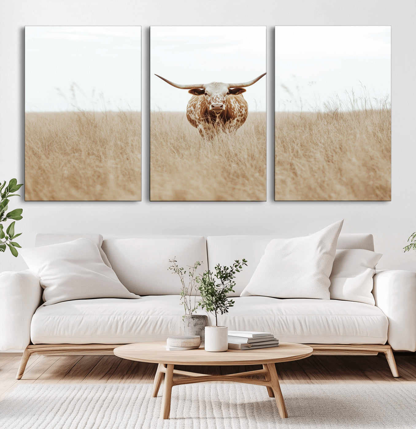Texas Longhorn bull standing alone in dry grass with neutral tones, ideal for rustic western or cowboy-themed wall decor.