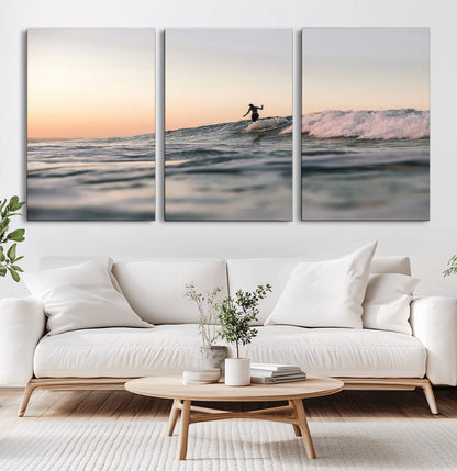 Framed canvas of a female surfer balancing on a wave at sunset, perfect for serene surf or ocean-inspired coastal decor.