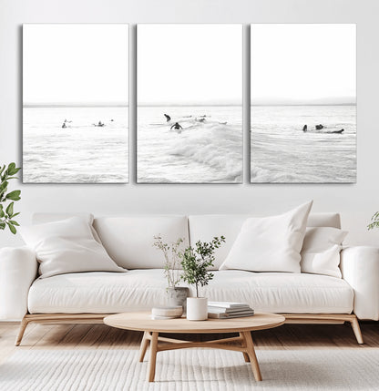 Monochrome photo of surfers riding and waiting on ocean waves, ideal for surf-themed or coastal energy wall decor.