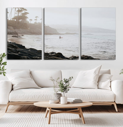 Framed canvas of a surfer in misty coastal tones at a foggy California beach, ideal for minimalist coastal beach or serene ocean-themed decor.