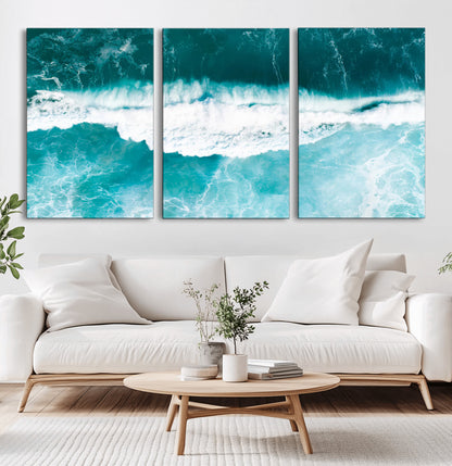 Aerial view of turquoise ocean waves crashing with white foam, perfect for tropical coastal or modern beach-style home decor.