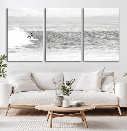 Monochrome photo of a surfer riding a wave with distant mountains, ideal for coastal motion or black and white surf-themed wall decor.