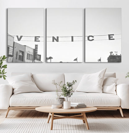 Black and white photo of Venice Beach sign and palm-lined street, perfect for urban coastal or minimalist LA-inspired wall decoration.