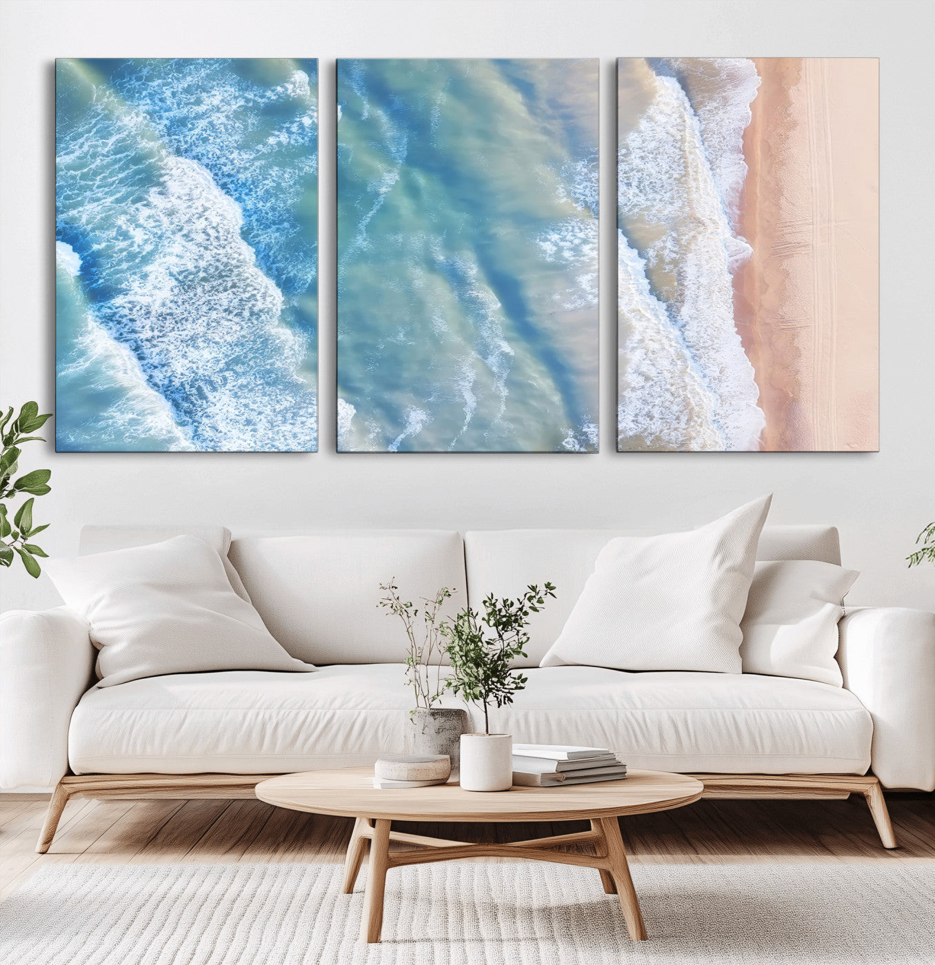 Aerial photo of soft blue waves meeting sandy shore, perfect for modern coastal or beach-themed decor with a light and tranquil aesthetic.