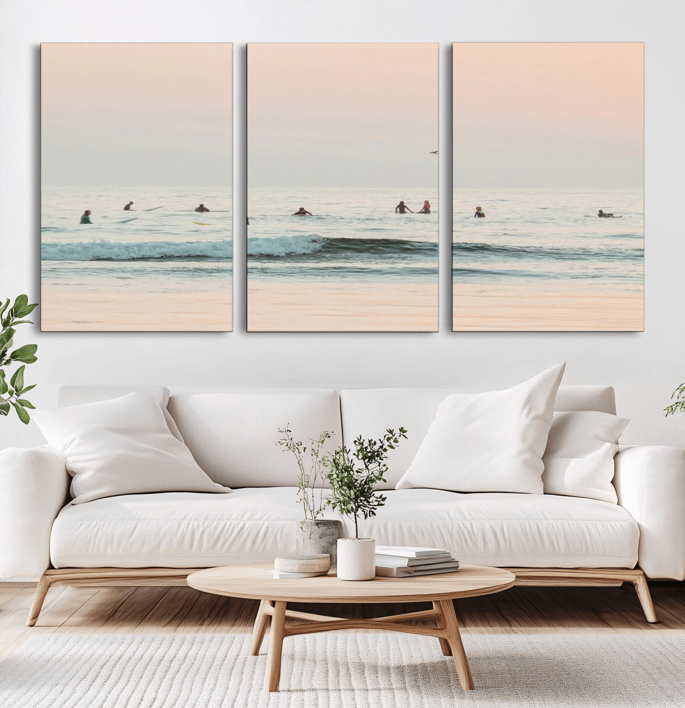 Dreamy photo of surfers waiting on soft pastel waves under a pink sunset sky, ideal for soft coastal minimalist or serene ocean-themed home decor.