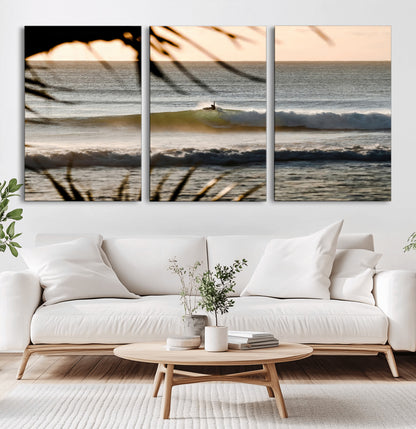 Photo of a surfer riding a golden hour wave at sunset, with tropical tones and dreamy light, perfect for tropical boho or coastal home decor.