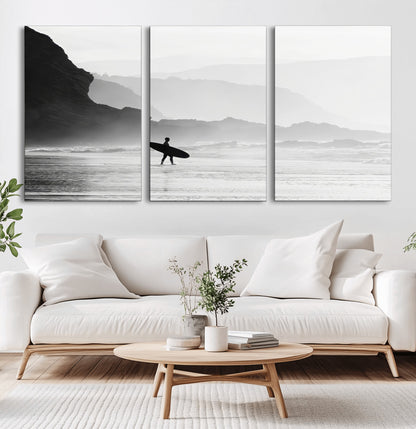 A lone surfer walking along a misty beach with cliffs in the background, carrying their board, capturing a serene and minimal ocean moment.