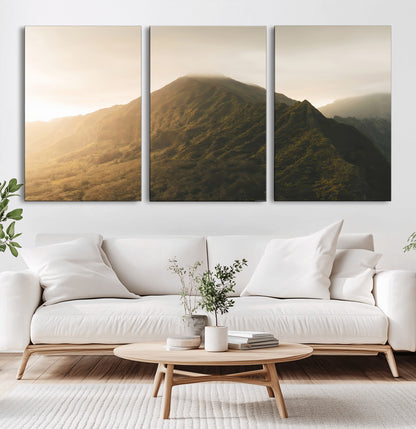 Sunlit mountain peak with mist rolling over its rugged slopes, bathed in golden light, creating a warm and tranquil nature-inspired scene.