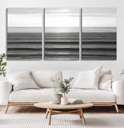 Minimalist black and white ocean view with layered waves reflecting sunlight, evoking a sense of calm and coastal serenity.