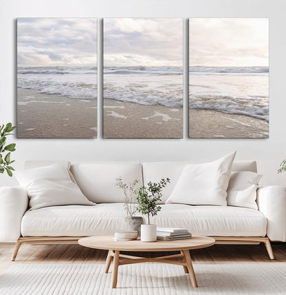 Peaceful ocean waves rolling onto the sandy shore under soft light, perfect for neutral or coastal minimalist decor themes.