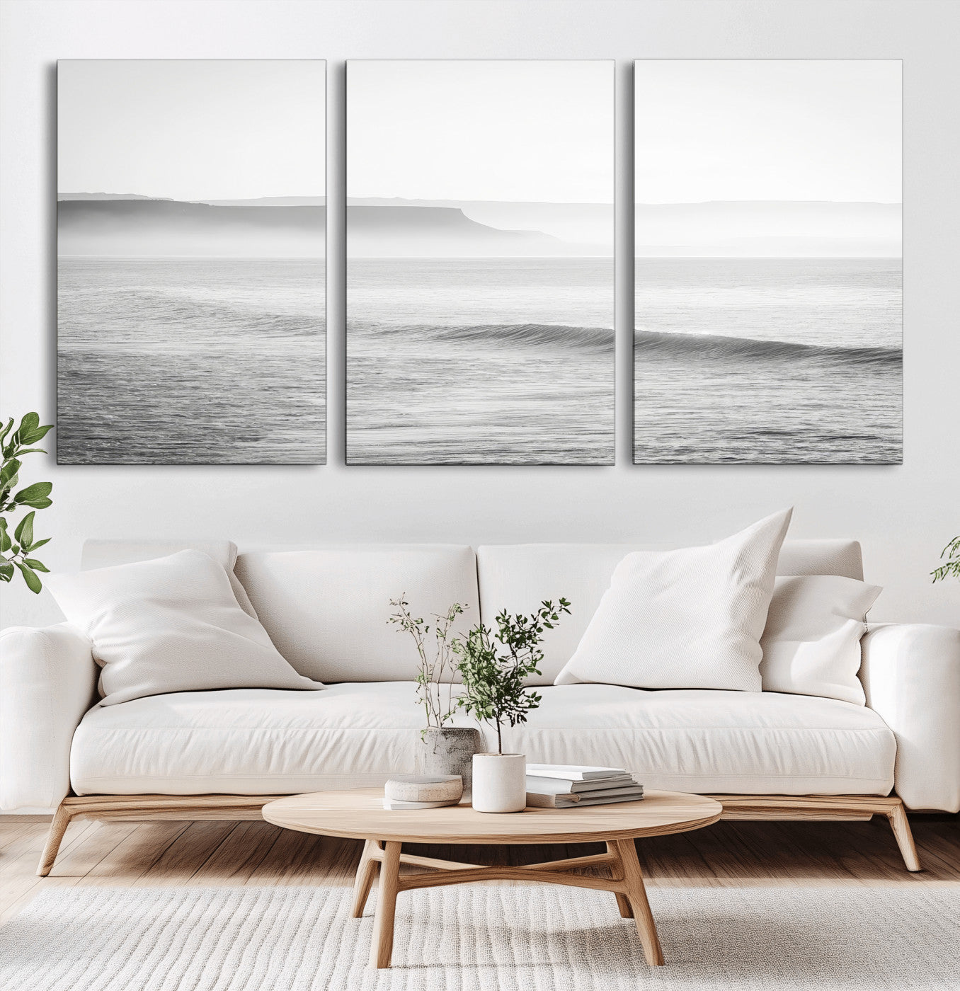 A black and white minimalist seascape featuring soft rolling waves and misty distant cliffs, creating a serene and timeless coastal atmosphere.