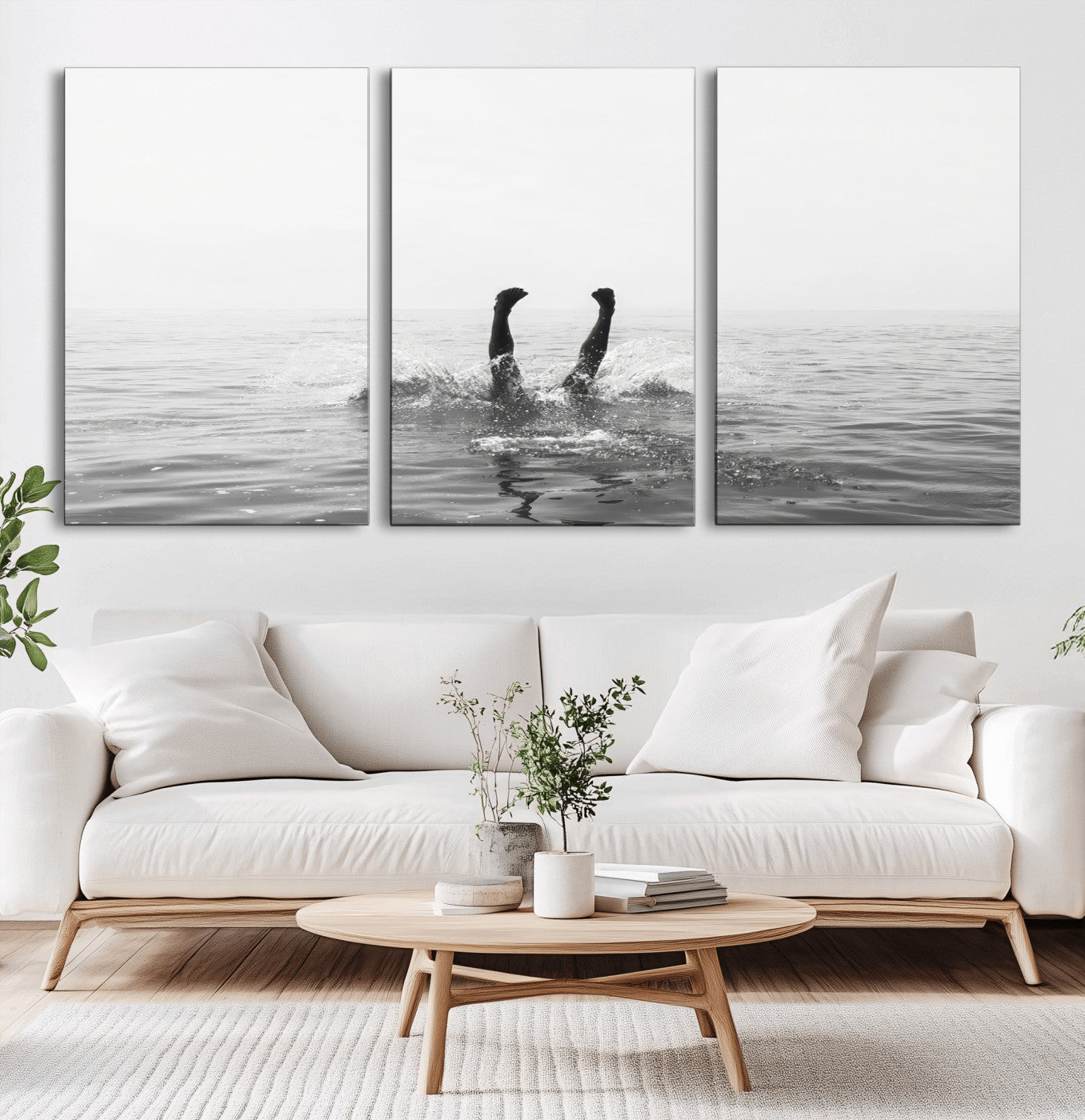 A black and white minimalist water scene capturing a playful splash as a swimmer dives upside down, creating a carefree and artistic aquatic aesthetic.