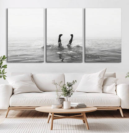 A black and white minimalist water scene capturing a playful splash as a swimmer dives upside down, creating a carefree and artistic aquatic aesthetic.