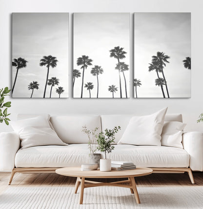 A black and white minimalist scene featuring tall palm trees silhouetted against a bright sky, creating a dreamy and timeless tropical aesthetic.