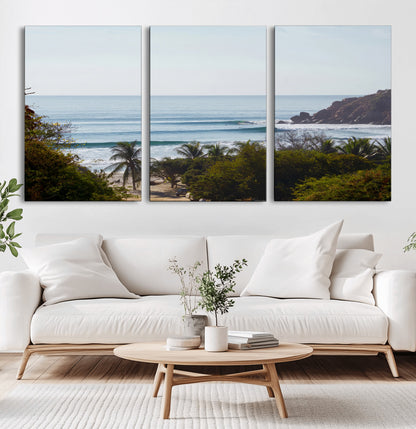 View of calm ocean waves with palm trees and a tropical coastline, ideal for coastal boho or beach-themed wall decor.