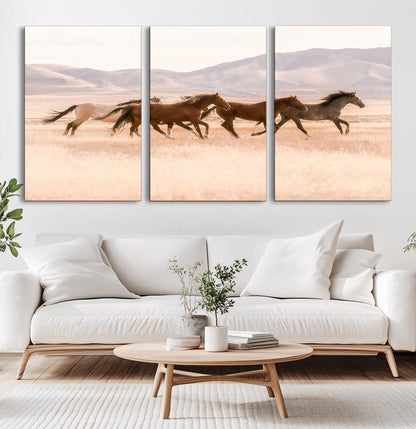 A herd of wild horses galloping through a sunlit desert plain with mountains in the background, perfect for rustic or western-themed wall decor.