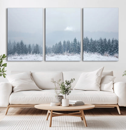 Snow-covered forest under misty sky, soft light breaking through clouds, ideal for minimalist or Nordic-inspired home decor.