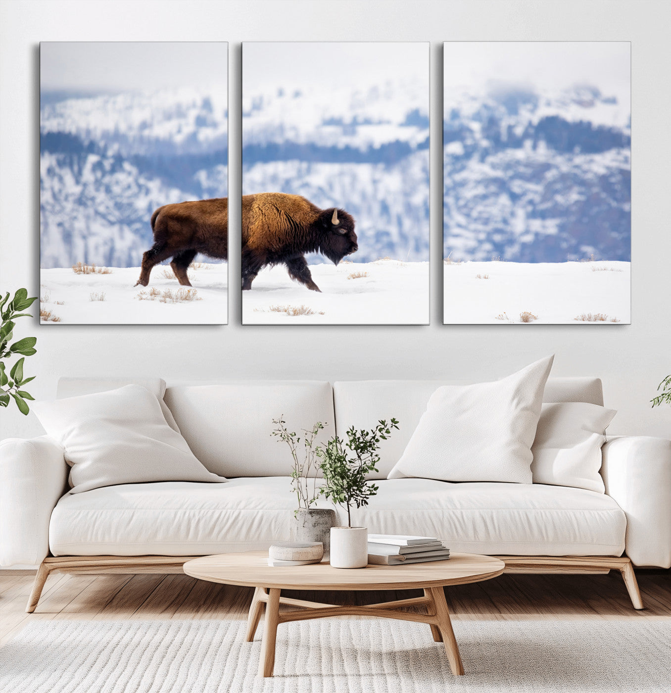 A lone bison walks across snowy ground with blue-toned mountain range behind, ideal for rustic or western farmhouse interiors.