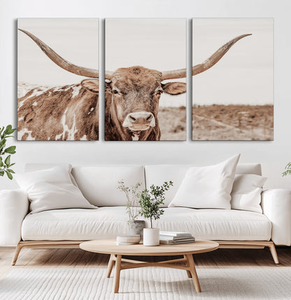 A longhorn cow in soft beige desert tones, standing calmly in open land, perfect for neutral western or rustic farmhouse interiors.