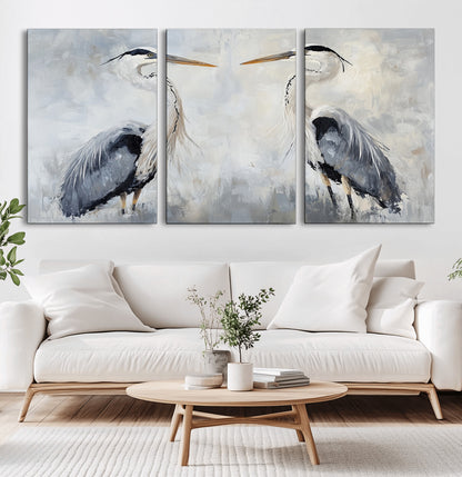 Two herons facing each other on a soft-toned background with blue-grey feathers, perfect for tranquil, coastal or nature-themed interiors.
