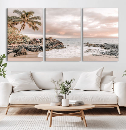 A peaceful beach scene with a palm tree and rocks, soft waves washing onto the shore under a soft pastel sky at sunset.