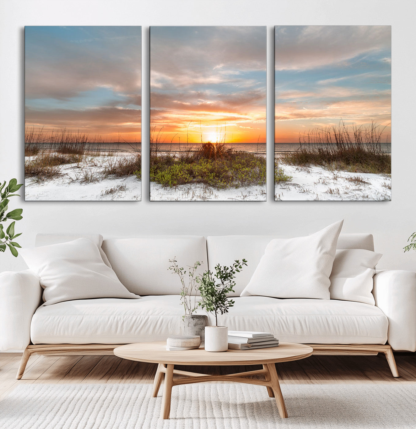 A tranquil beach scene featuring golden sunset hues over the water, with grasses in the foreground and a peaceful, serene atmosphere.