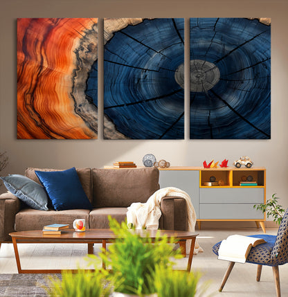 A captivating close-up of a tree trunk, showcasing its concentric rings in rich shades of blue, orange, and brown, highlighting the organic patterns of natural wood.