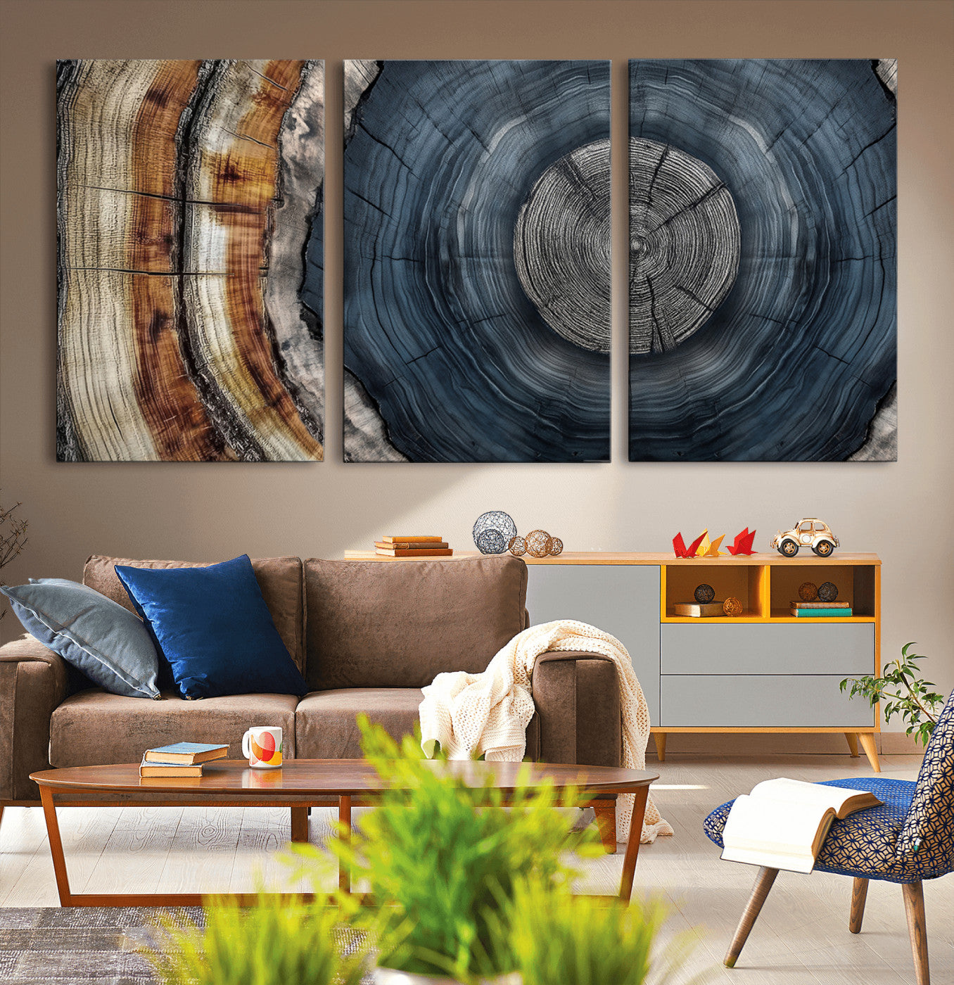 A stunning close-up of a tree trunk showing the intricate, circular growth rings, showcasing the natural textures and rich contrasts in deep blues, browns, and silvers.