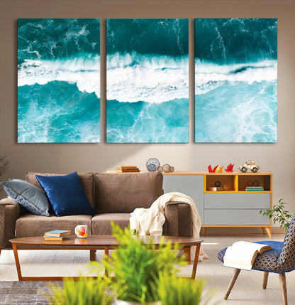 Aerial view of turquoise ocean waves crashing with white foam, perfect for tropical coastal or modern beach-style home decor.