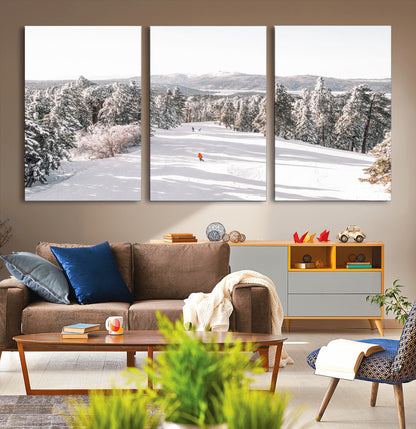 Bright ski trail lined with snow-covered pines and a skier in orange, perfect for alpine adventure or winter sports-inspired decor.