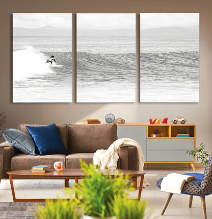 Monochrome photo of a surfer riding a wave with distant mountains, ideal for coastal motion or black and white surf-themed wall decor.